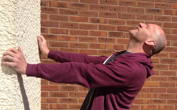 Author David Moody bangs his head against a wall