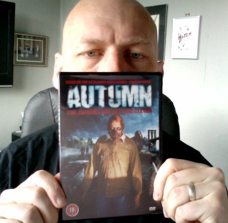David Moody posing with the DVD of the movie adaptation of his novel AUTUMN